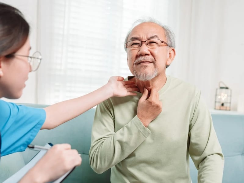 Elderly patient speaking with healthcare professional